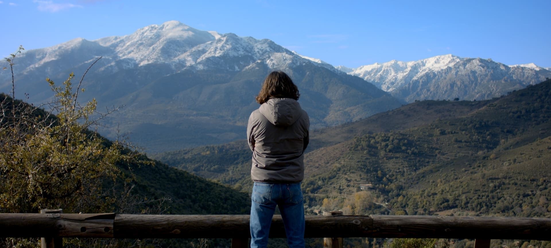 A man in front of a mountain.